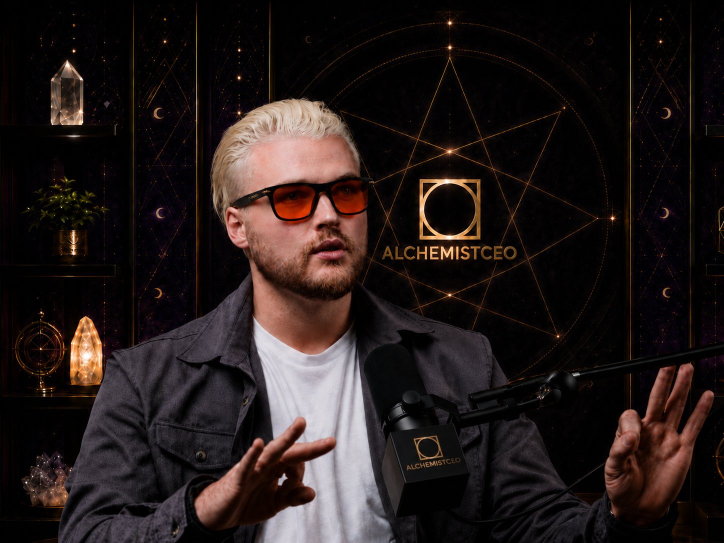 Dylan Vanas, host of the AlchemistCEO podcast, in the studio wearing orange-tinted glasses
